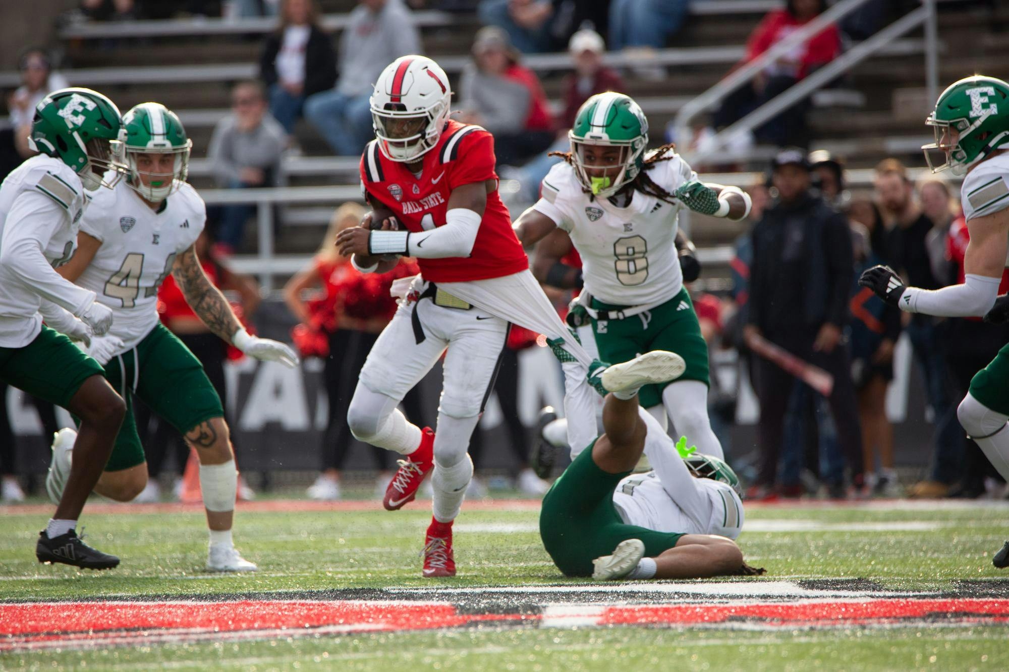 Redshirt Senior quarterback Kiael Kelly gets tackled by Eastern Michigan football players Nov. 15 at Scheumann Stadium. Kelly has had 1,155 passing yards this season. Mallory Hall, DN
