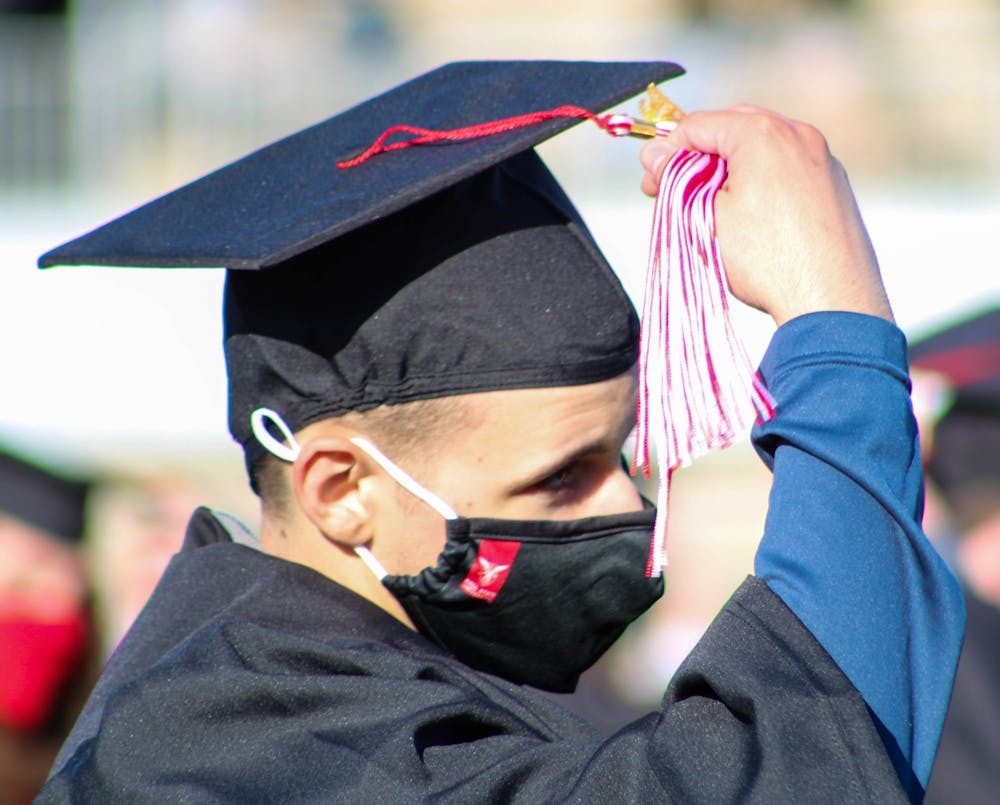 <p>A new graduate moves his tassel from the left to the right May 8, 2021, at Scheumann Stadium. The spring 2021 commencement ceremonies were held at Scheumann Stadium for the first time in Ball State history due to social distancing procedures. Fall 2021 graduation ceremonies will be held at Worthen Arena with masks required. <strong>Jaden Whiteman, DN File</strong></p>