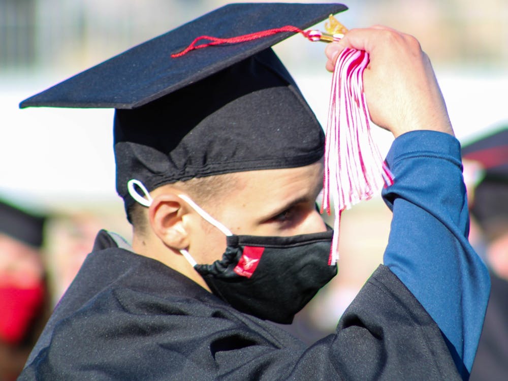 A new graduate moves his tassel from the left to the right May 8, 2021, at Scheumann Stadium. The spring 2021 commencement ceremonies were held at Scheumann Stadium for the first time in Ball State history due to social distancing procedures. Fall 2021 graduation ceremonies will be held at Worthen Arena with masks required. Jaden Whiteman, DN File