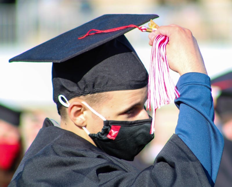 A new graduate moves his tassel from the left to the right May 8, 2021, at Scheumann Stadium. The spring 2021 commencement ceremonies were held at Scheumann Stadium for the first time in Ball State history due to social distancing procedures. Fall 2021 graduation ceremonies will be held at Worthen Arena with masks required. Jaden Whiteman, DN File