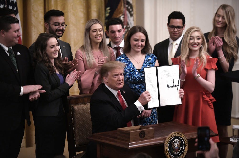 <p>U.S. President Donald Trump holds a signed executive order to require colleges and universities to "support free speech" on campus or risk loss of federal research funds during an event in the East Room of the White House on Thursday, March 21, 2019. <strong>(Olivier Douliery/Abaca Press/TNS)</strong></p>