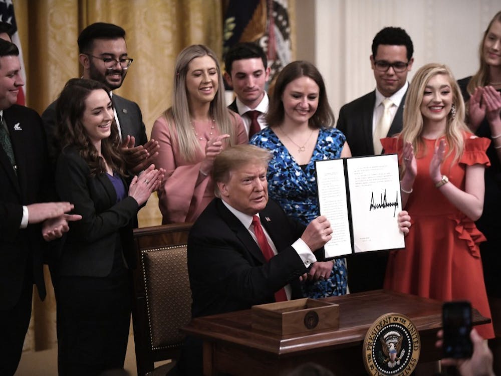 U.S. President Donald Trump holds a signed executive order to require colleges and universities to "support free speech" on campus or risk loss of federal research funds during an event in the East Room of the White House on Thursday, March 21, 2019. (Olivier Douliery/Abaca Press/TNS)