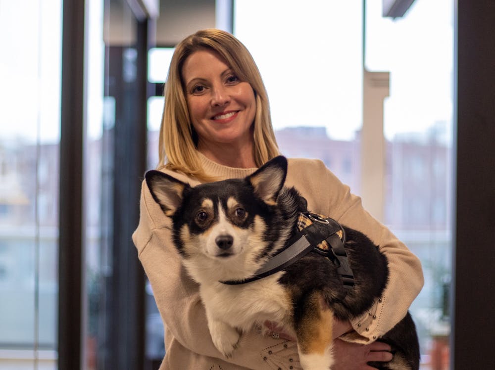 <p>Kimberly Jeselski stands with her "office dog" Babette Jan. 17, 2020, in Indianapolis Ind. Babette stays in Jeselski's office but will wander around the office space and sometimes into other people's offices. <strong>Jacob Musselman, DN</strong></p>