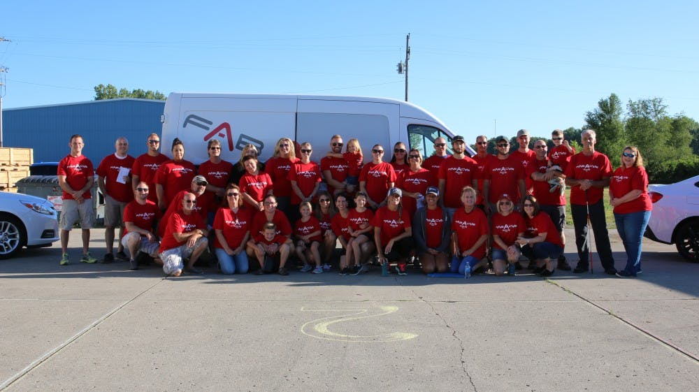 <p>Members of the Middletown, Ind. community and staff of FAB-A-CAB rallied for a quick group photo before starting the day of service event.</p>