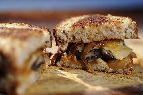 Senior photojournalism major Tyler Stewart makes a mushroom melt along with a gazpacho slaw and a side salad. Both the salad and and mushroom melt incorporate alcohol, such as a pale-ale beer and whiskey. PHOTO PROVIDED BY TYLER STEWART