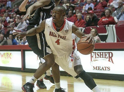 Jauwan Scaife barrels past a Northern Illinois University defender during the game in Worthen Arena on March 9. Scaife scored a total of 28 points during the game, with 7 3-pointers against Buffalo in the MAC Tournament. DN PHOTO JORDAN HUFFER