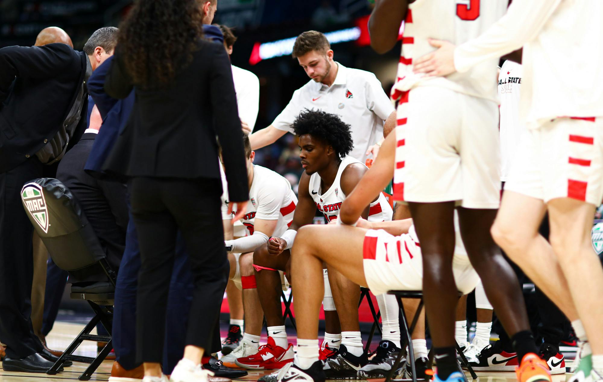 Sophomore guard Jaylin Sellers listens to head coach Michael Lewis in a huddle in a MAC Tournament Quarterfinal game against Ohio at Rocket Mortgage Fieldhouse March 9 in Cleveland. Jacy Bradley, DN