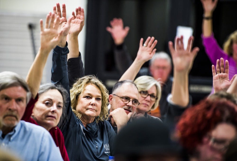 Anne Krajcovic from precinct 102 participates in a straw poll for Hillary Clinton during the Democratic caucus at Coronado High School in Colorado Springs, Colo., on Tuesday, March 1, 2016. (Stacie Scott/Colorado Springs Gazette/TNS)