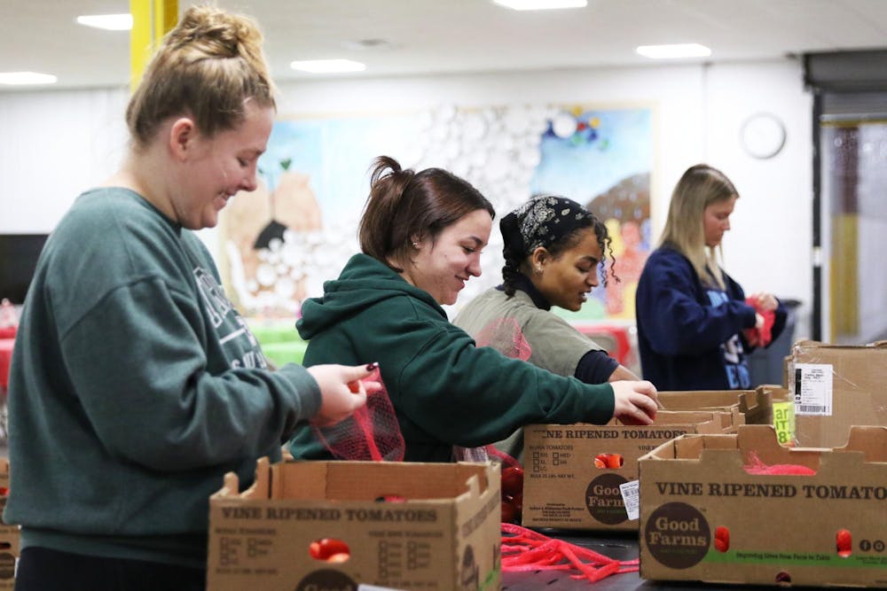 A group of volunteers sort tomatoes Dec. 1 at Second Harvest food bank in Muncie, Indiana. Trinity Rea, DN