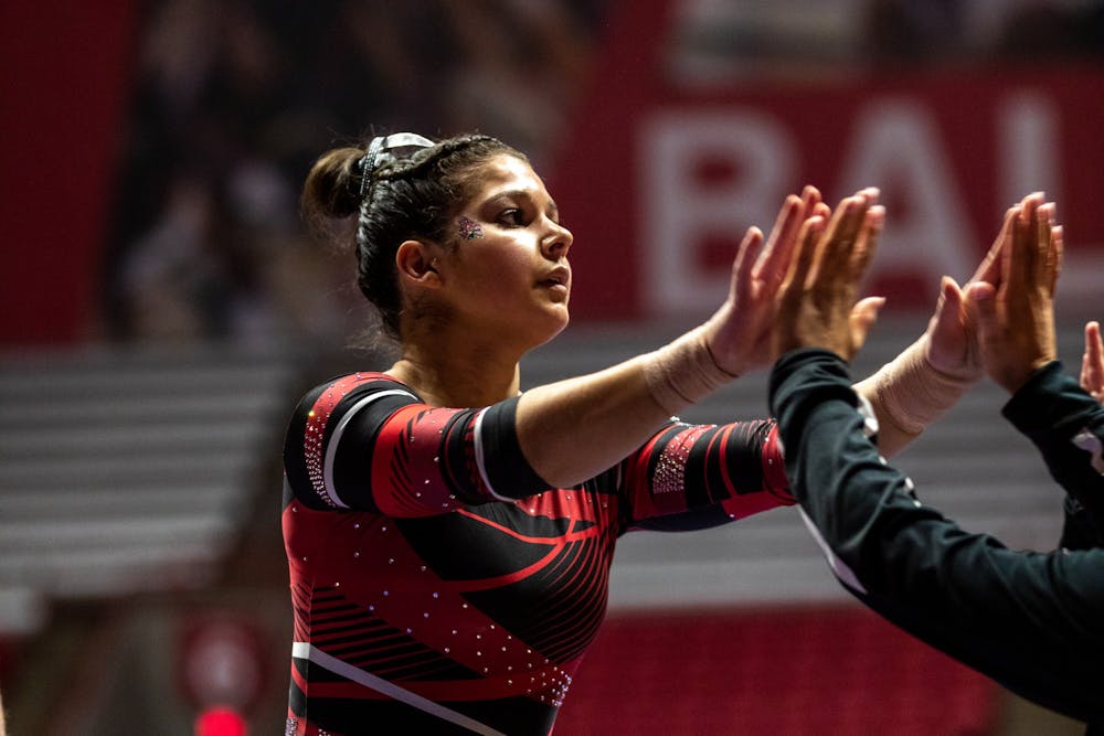 Ball State Senior, Rachel Benoit high fives her teammates as she completes the beam routine during the women's gymnastics home opener, Jan. 26, 2020 in John E. Worthen Arena. The Cardinals secured a win by putting up 194.2 points. Paul Kihn, DN