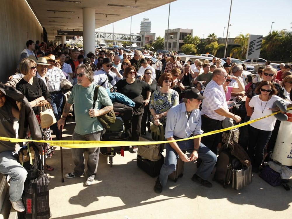 Passengers leave LAX after a suspect believed to be armed with an assault rifle opened fire inside Terminal 3 at Los Angeles International Airport on Nov. 1. A Transportation Security Administration agent was killed and several others, including the shooter, were wounded. MCT PHOTO