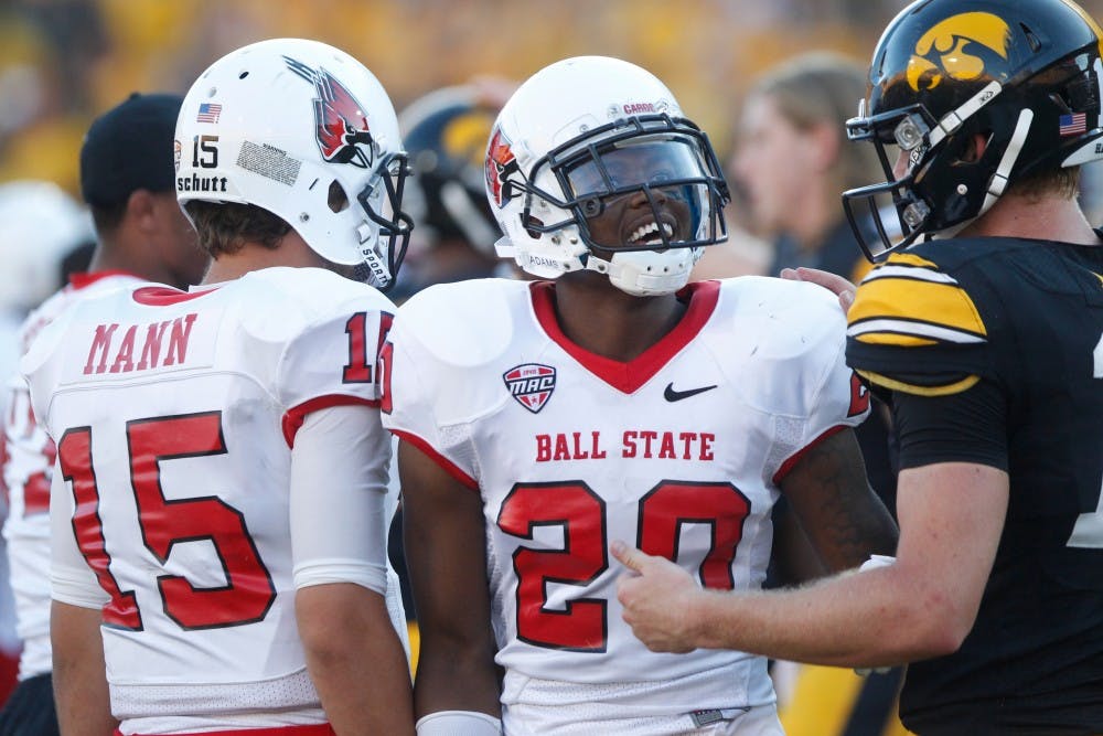 Ball State running back Jimmy Crumley talks to Iowa quarterback Jake Rudock after the game on Sept. 6 in Kinnick Stadium. Iowa defeated Ball State, 17-13. (The Daily Iowan/Rachael Westergard)