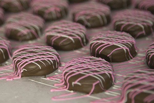 Colocate covered Oreos harden in the candy making room at Lowery's in Yorktown. These were just one of the many types of coverings that the small company had put out for this years's holiday. DN PHOTO JORDAN HUFFER