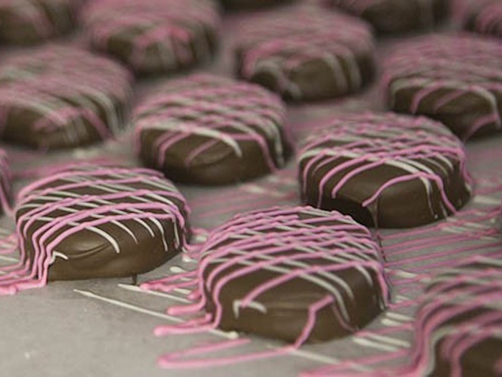 Colocate covered Oreos harden in the candy making room at Lowery's in Yorktown. These were just one of the many types of coverings that the small company had put out for this years's holiday. DN PHOTO JORDAN HUFFER
