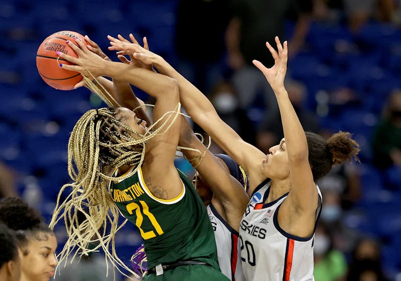 DiJonai Carrington #21 of the Baylor Lady Bears tries to take a shot as Aaliyah Edwards #3 and Olivia Nelson-Ododa #20 of the UConn Huskies defend in the final minutes of the game during the Elite Eight round of the NCAA Women's Basketball Tournament at the Alamodome on March 29, 2021 in San Antonio, Texas.The UConn Huskies defeated the Baylor Lady Bears 69-67 to advance to the Final Four. (Elsa/Getty Images/TNS)