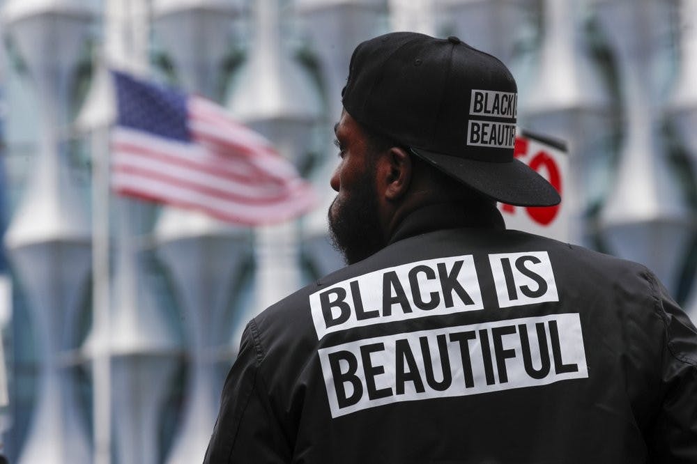 A protester stands in front of the US embassy during the Black Lives Matter protest rally June 7, 2020, in London in response to the recent killing of George Floyd by police officers in Minneapolis, USA, that has led to protests in many countries and across the US. (AP Photo/Frank Augstein)