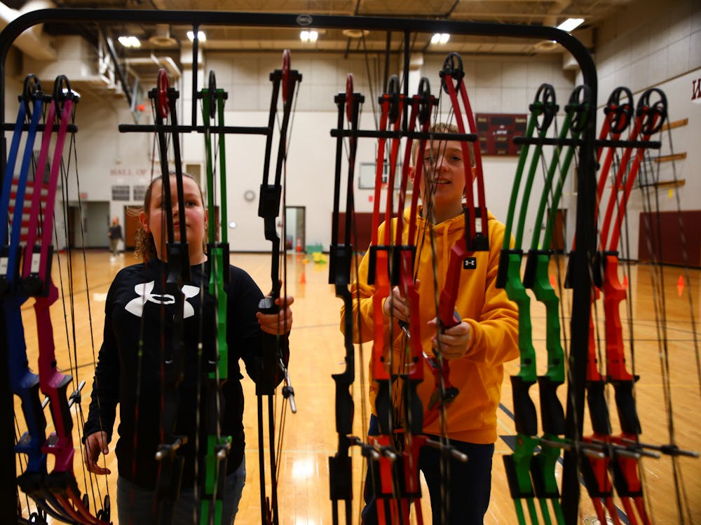 Wes-Del Elementary fifth grader Ava Johnson (right) and fifth grader Carter Carmin put their bows back March 29 at Wes-Del Elementary School. Jacy Bradley, DN