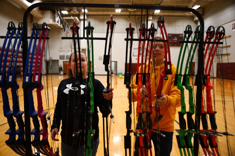 Wes-Del Elementary fifth grader Ava Johnson (right) and fifth grader Carter Carmin put their bows back March 29 at Wes-Del Elementary School. Jacy Bradley, DN