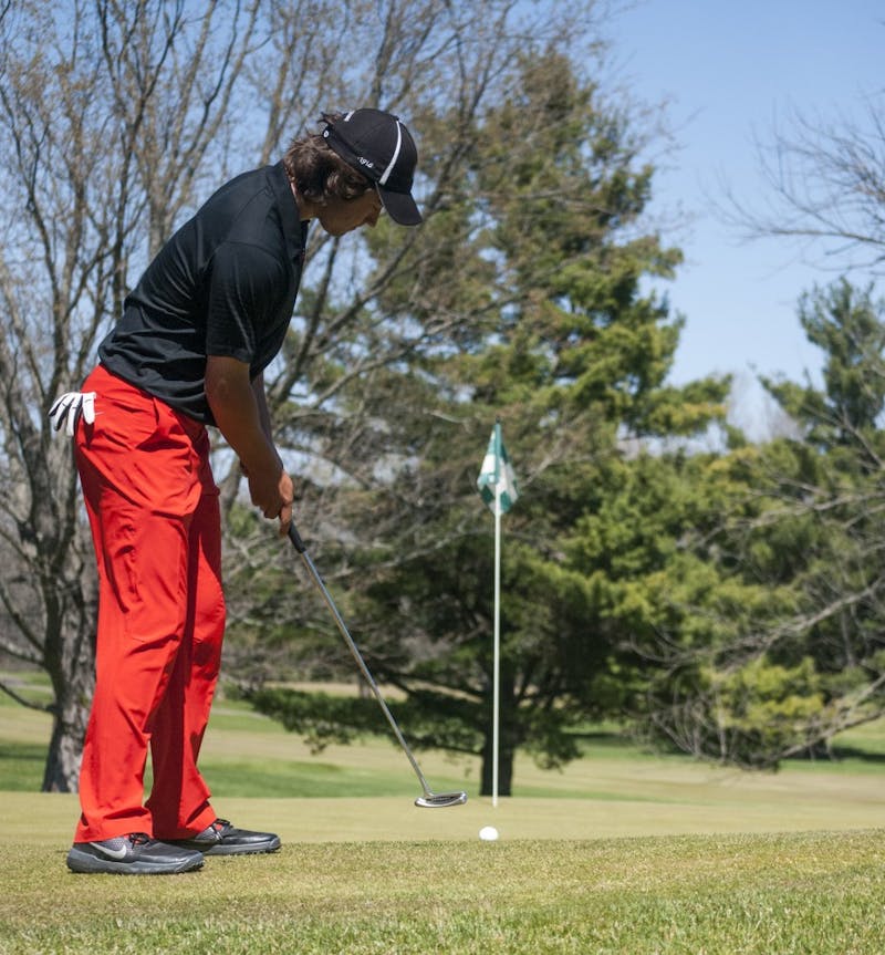 Sophomore Johnny Watts knocks down a 35-foot put for a birdie on the 17th hole at Delaware Country Club in Muncie. Watts birdied on four of the last five holes in the Earl Yestingsmeier Invitational and finished tied for second. DN PHOTO COLIN GRYLLS