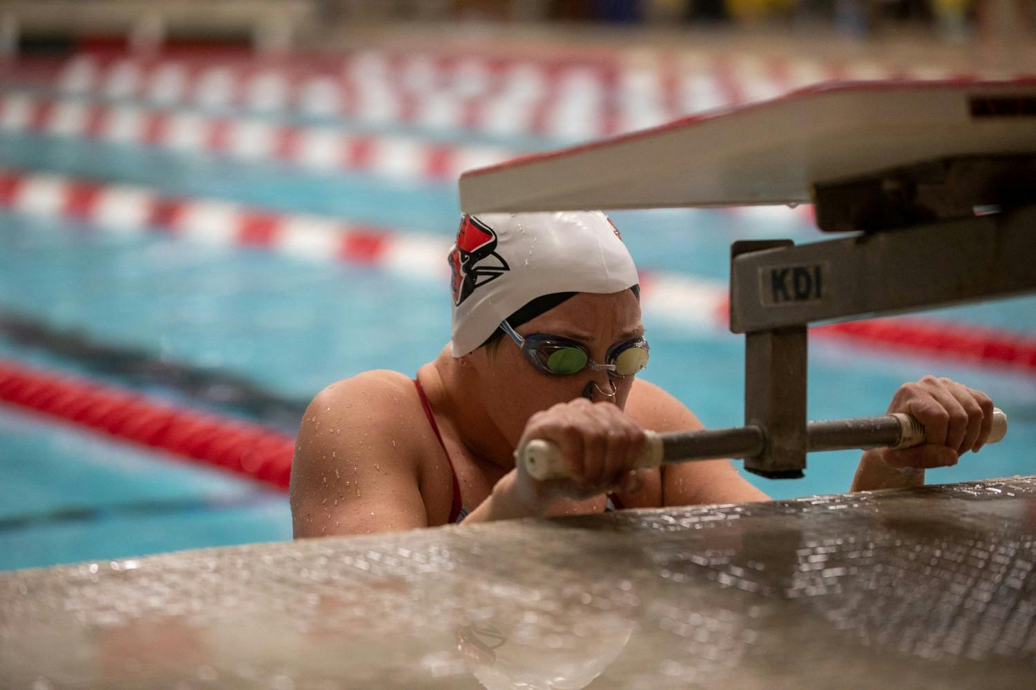 Senior Anne Vormohr takes her mark in the 100-Backstroke Jan. 16, 2020, in Lewellen Aquatics Center. The Cardinals won 193-105. Jacob Musselman, DN