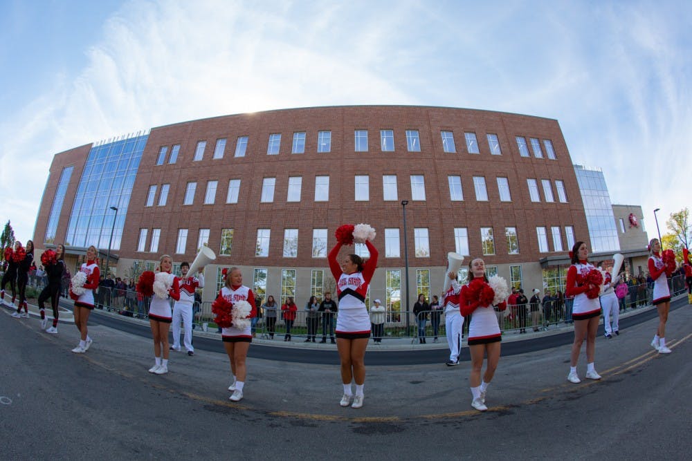 Ball State University cheerleaders kick off the festivities during the Homecoming bed races Oct. 18, 2019 on Riverside Avenue. Bed races have been a Homecoming Week traditional at Ball State since 1980. Kyle Crawford, Byte File