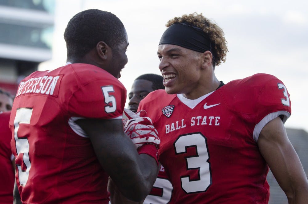 Eric Patterson, a junior cornerback, left, and Willie Snead, a junior wide receiver, embrace each other after the win against Toledo on Sept. 28 at Scheumann Stadium. Ball State went on to win 31-24. DN PHOTO BREANNA DAUGHERTY 