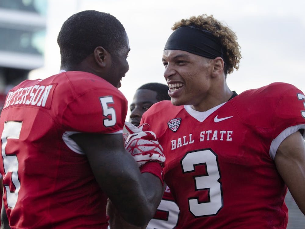 Eric Patterson, a junior cornerback, left, and Willie Snead, a junior wide receiver, embrace each other after the win against Toledo on Sept. 28 at Scheumann Stadium. Ball State went on to win 31-24. DN PHOTO BREANNA DAUGHERTY 