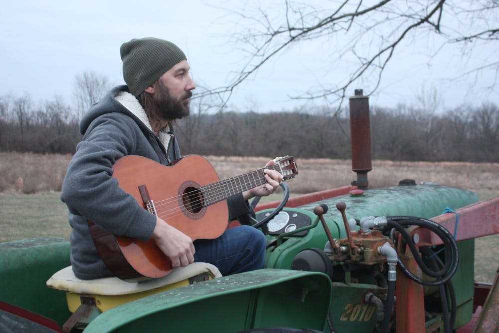 <p>Andrew Gustin, owner of Ameliorate Records and curator of &quot;Two Minutes in Indiana&quot; poses with his guitar Jan. 17, 2022. Gustin played his own track called &quot;Willow Tree&quot; on the album alongside individual compositions from 19 other Indiana musicians. <strong>Laura Hergenroether, Photo Provided</strong></p>