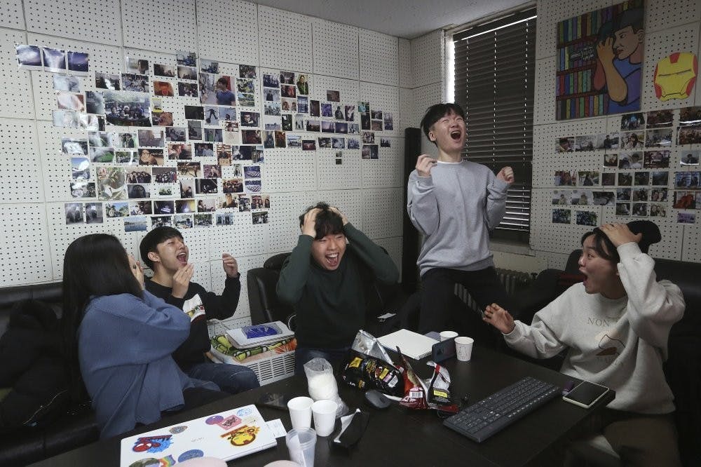 Film club members celebrate as they watch a TV live broadcasting of South Korean director Bong Joon Ho's "Parasite" receiving the award for best picture at the Oscars, Feb. 10, 2020, at the Yeonsei University in Seoul, South Korea. (AP Photo/Ahn Young-joon)