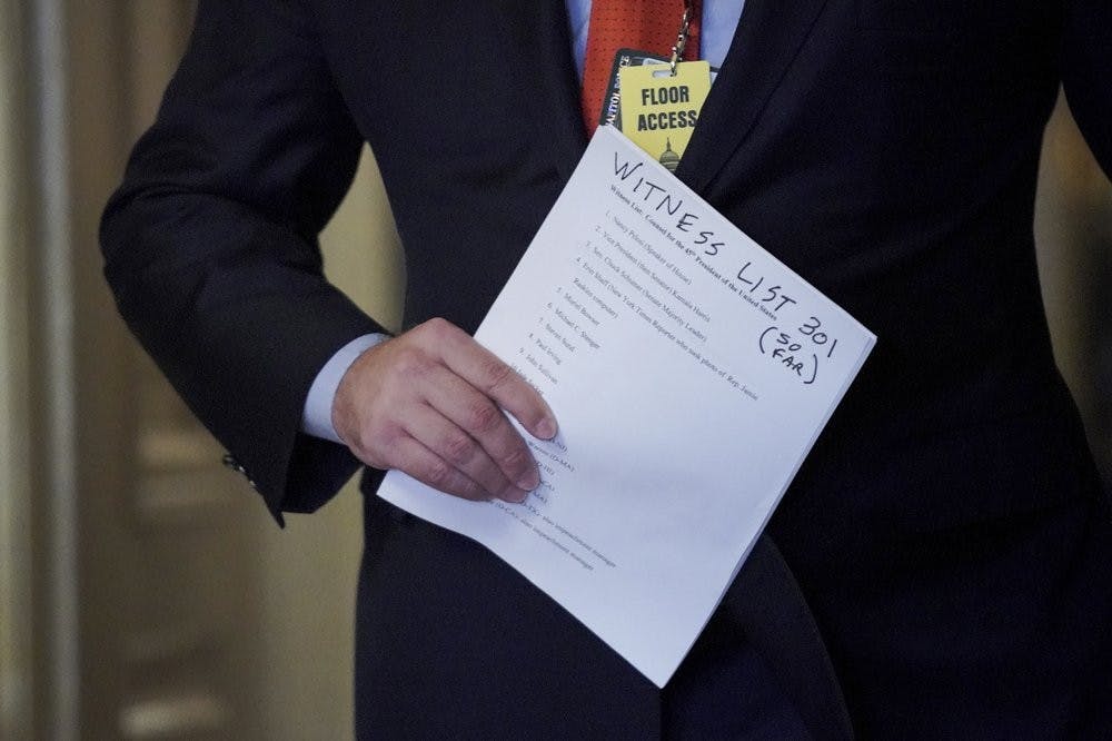 Jason Miller, Senior Adviser to the Trump 2020 re-election campaign, holds a list on the fifth day of the second impeachment trial of former President Trump, Saturday, Feb. 13, 2021 at the Capitol in Washington. (Greg Nash/Pool via AP)