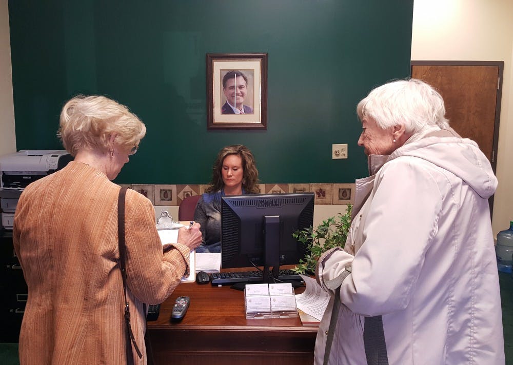 District 34 representative Sue Errington, left, protests congressman Luke Messer's office on Walnut Street Nov. 30. Sara Barker, DN
