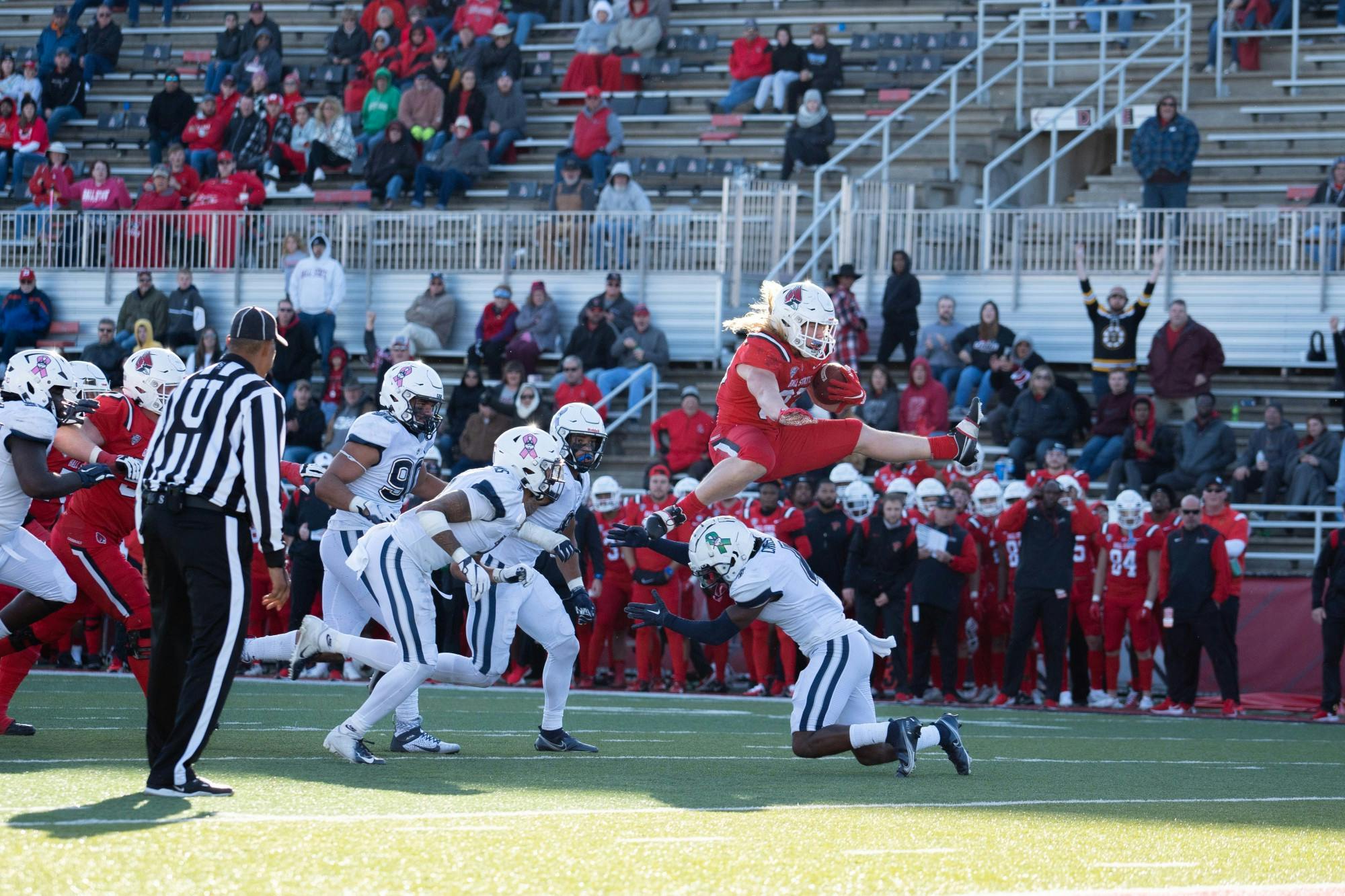 Second-year running back Carson Steele hurdles over a player with the football in a game against University of Connecticut Oct. 15 at Scheumann Stadium. Steele's longest run of the game was for 25 yards. Eli Pierson, DN