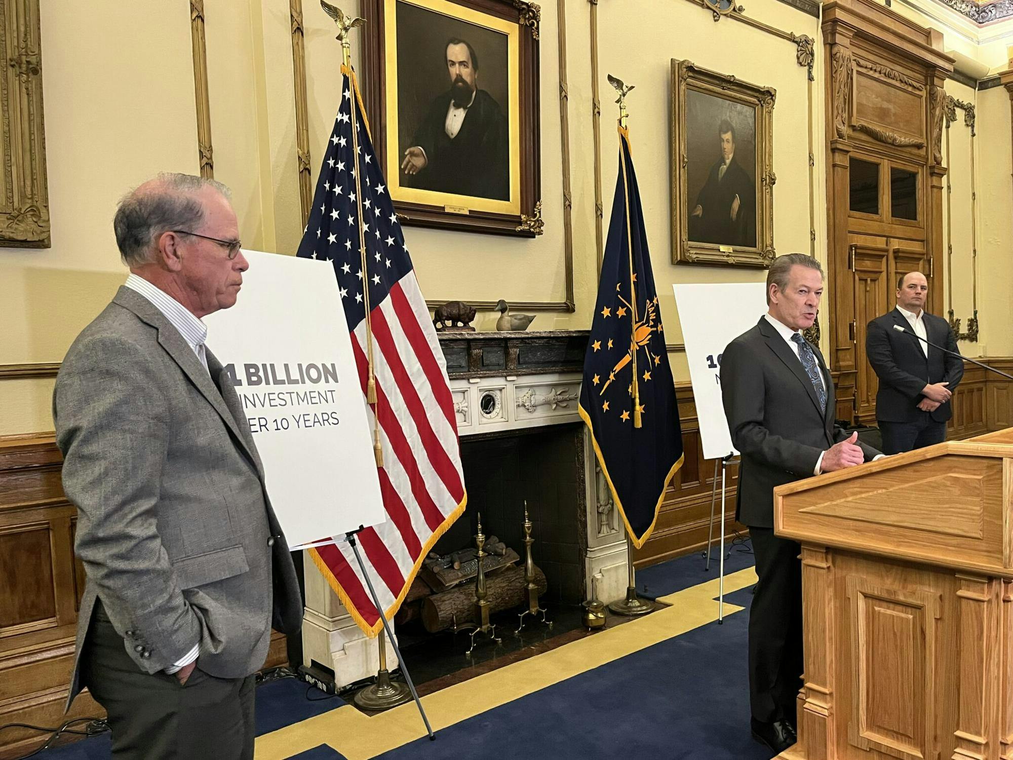 Commerce Secretary David Adams, center, speaks at a Statehouse event in the Governor’s Office on Tuesday, March 17, 2015. Gov. Mike Braun, left, and Fishers Mayor Scott Fadness, right, also participated. (Photo by Niki Kelly/Indiana Capital Chronice)