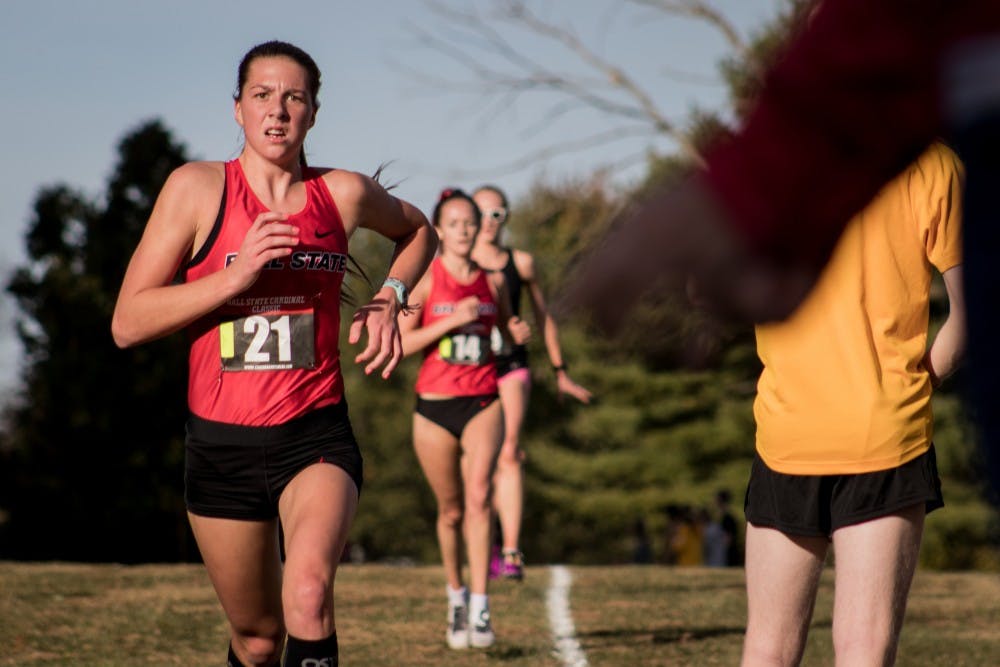 <p>Freshman Juliana Stogsdill runs down the backstretch of the cross country meet as spectators cheer the runners on Oct. 18, 2019, at the Muncie Elks Golf Corse. Ball State Finished first overall for the women with a perfect score. <strong>Eric Pritchett, DN</strong></p>