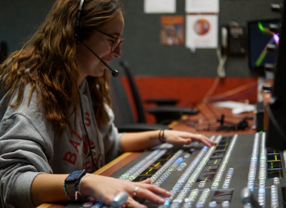 First-year digital sports production major Elyse Timpe poses in the broadcast booth in Ball Communication Jan. 23, 2022. Daniel Kehn, DN