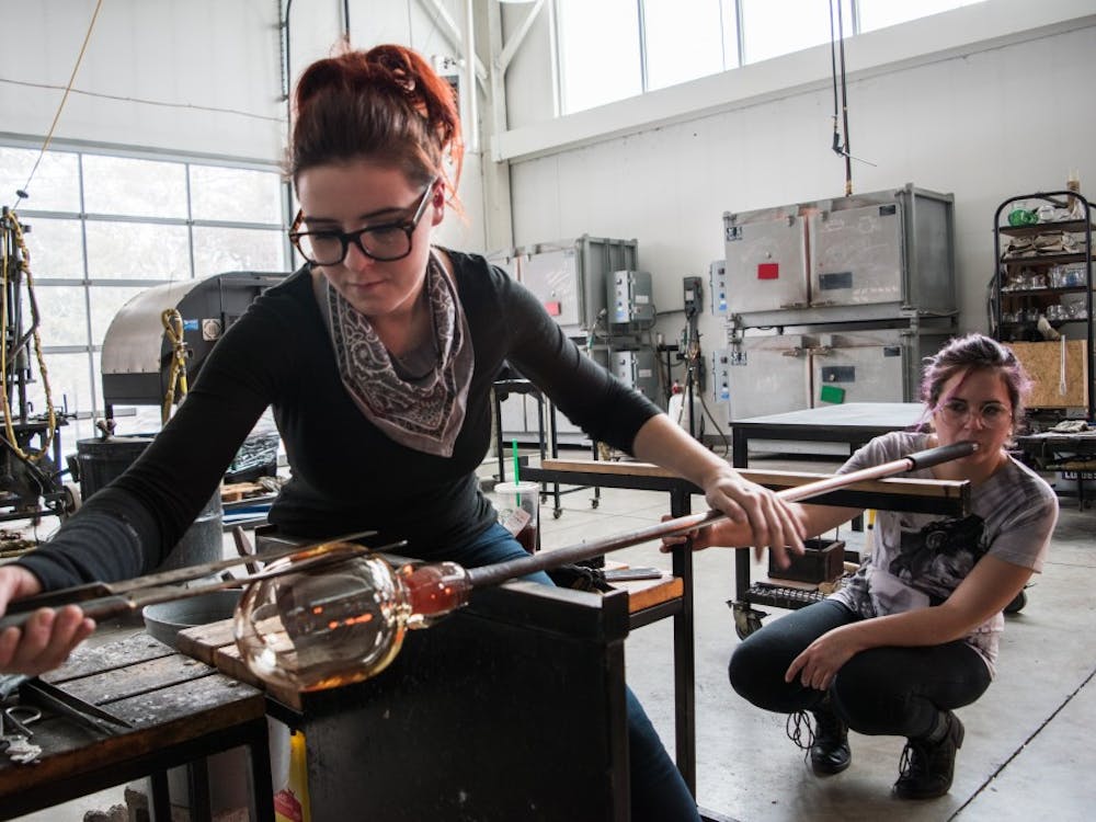 Ally Burch, a graduate student, works on a glass piece with Kat Rudolph at the Marilyn K. Glick Center for Glass. Stephanie Amador, DN