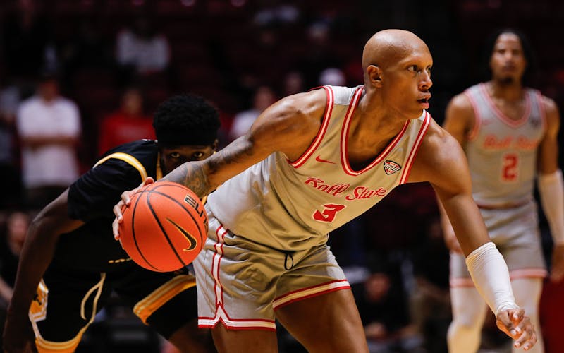 Ball State senior forward Mickey Pearson Jr. dribbles the ball away from Southern Miss defense Feb. 8 at Worthen Arena. Pearson had one assist in the game. Andrew Berger, DN 