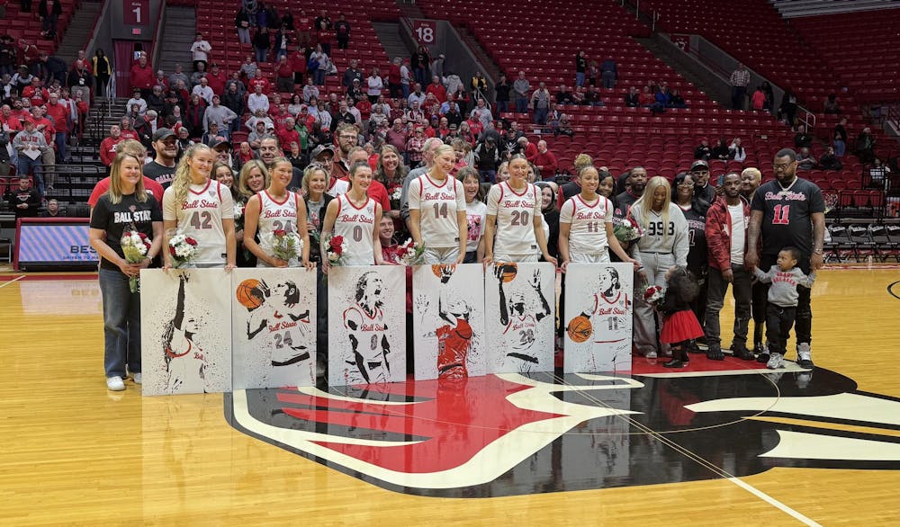 The seniors for Ball State women's basketball pose at center court following a ceremony. The Cardinals defeated Ohio 82-57. Elijah Poe, DN