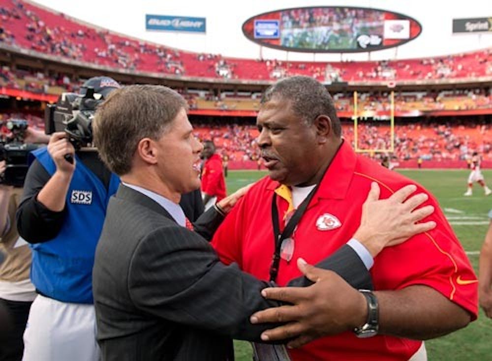 Kansas City Chiefs head coach Romeo Crennel, center, receives an embrace from Chiefs CEO Clark Hunt following the team’s 27-21 win over the Carolina Panthers on Sunday at Arrowhead Stadium in Kansas City, Mo. Crennel and his general manager Scott Pioli witnessed the murder-suicide of linebacker Jovan Belcher. MCT PHOTO