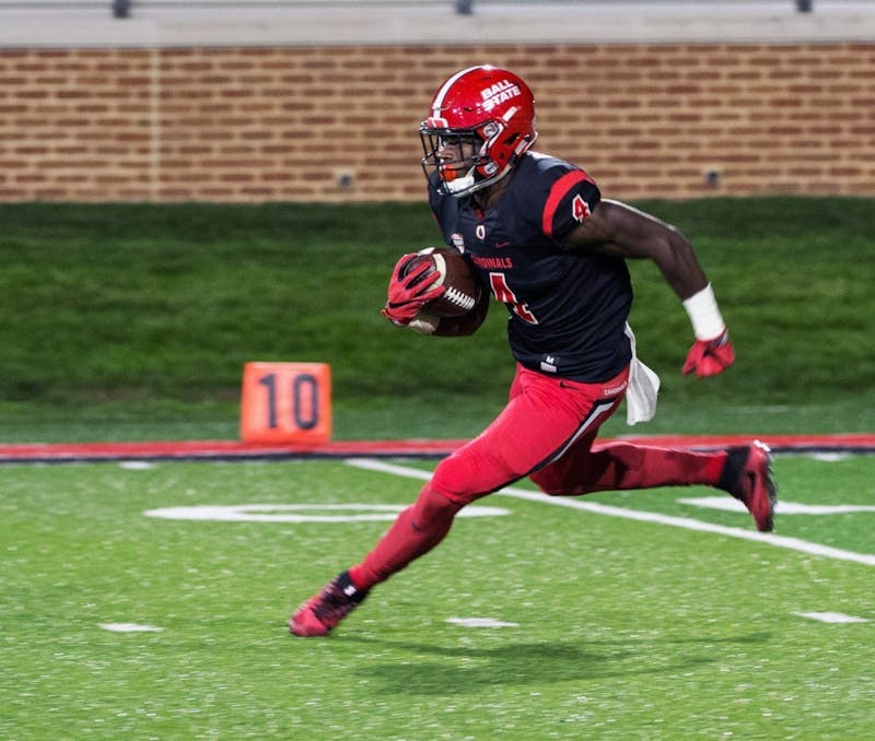 Sophomore running back Malik Dunner runs the ball down the field during the Cardinals’ game against Toledo on Oct. 26 at Scheumann Stadium. Dunner had 62 rushing yards for gain. Ian Elliott, DN File