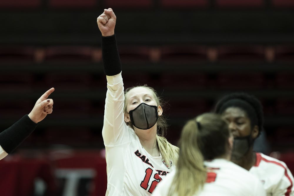 Cardinals freshman outside hitter Cait Snyder celebrates with her team after scoring a point against Central Michigan University March 19, 2021, at John E. Worthen Arena. The Cardinals beat the Chippewas 3-2. Jacob Musselman, DN