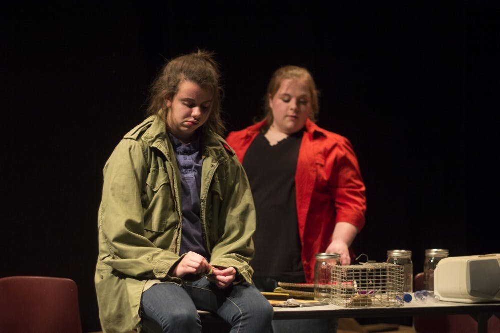 Moo and Greta, played by Lauren Fivek and Mary Taylor, talk in the basement during a scene from 