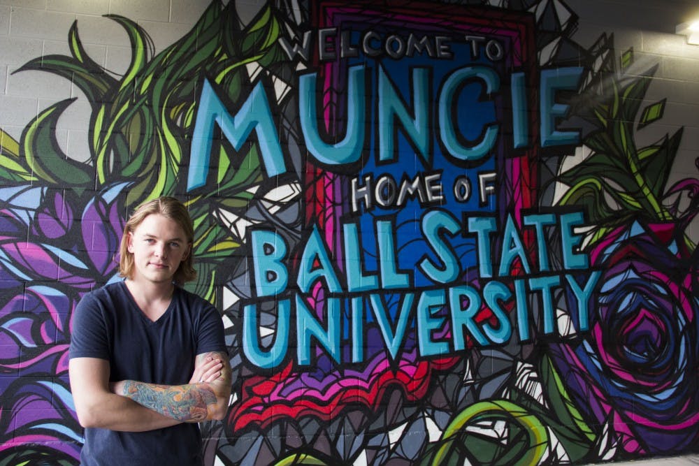 <p>Senior visual communications major Eric Jones was asked to create a mural for Village Promenade after they contacted the art department looking for an artist. This was Jones’ first large-scale commission project including brightly colored shapes, Ball State imagery and nature scenes. <em>DN PHOTO EMMA ROGERS</em></p>
