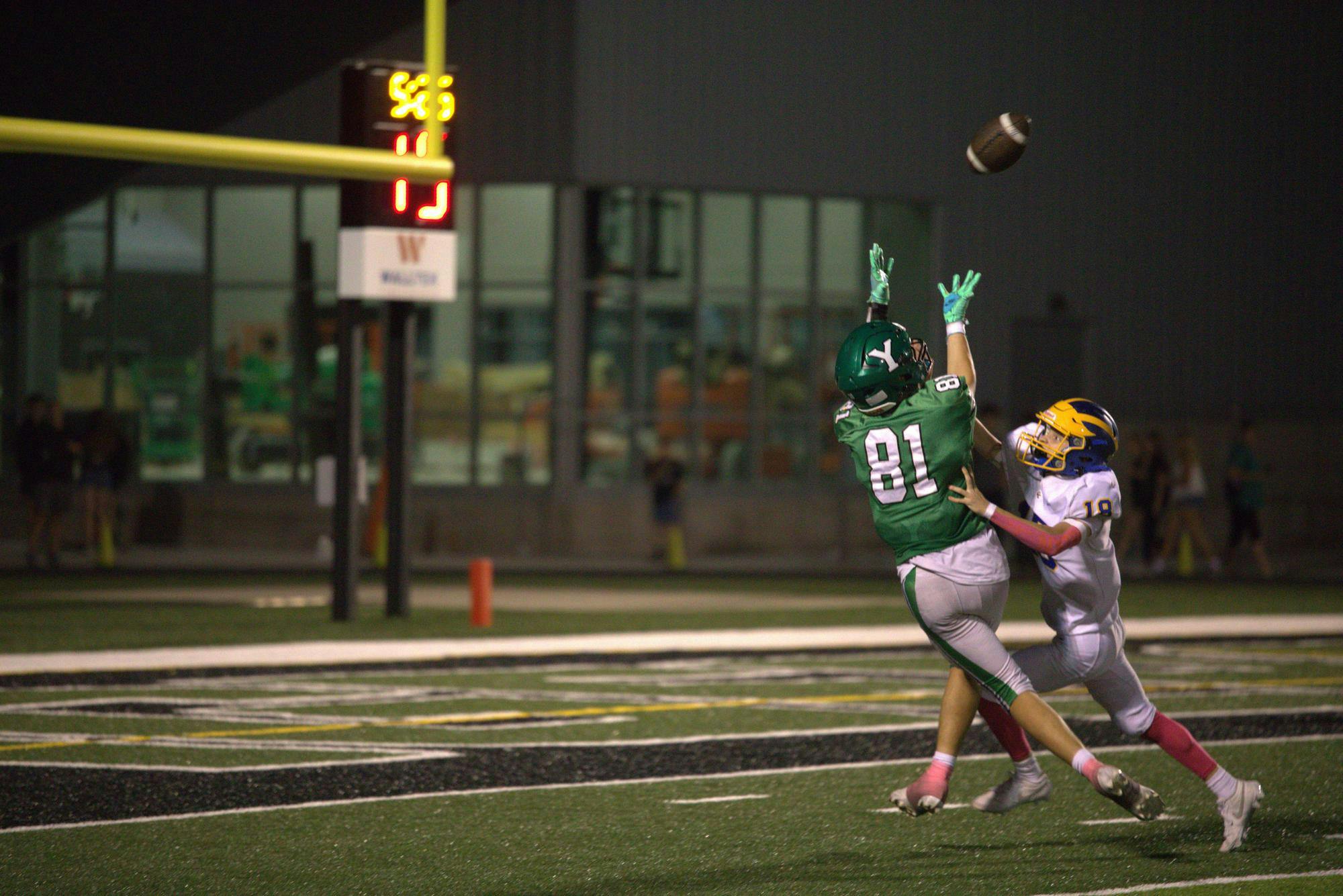 Yorktown senior receiver Cole Perdue extends his arms attempting a catch Oct. 3 against Greenfield-Central. Perdue is one of ten seniors on the team to celebrate senior day. 