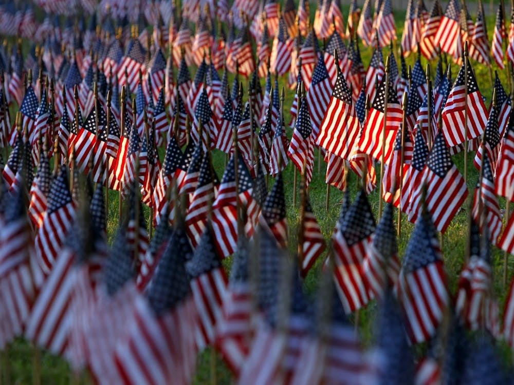 Shafts of early morning sunlight wash across rows of flags placed in front of Beaumont High School in St. Louis, Mo., Sept. 11, 2013. Students at the school put up about 3,000 flags after school as a tribute to the people who lost their lives in the attacks of Sept. 11, 2001. MCT PHOTO