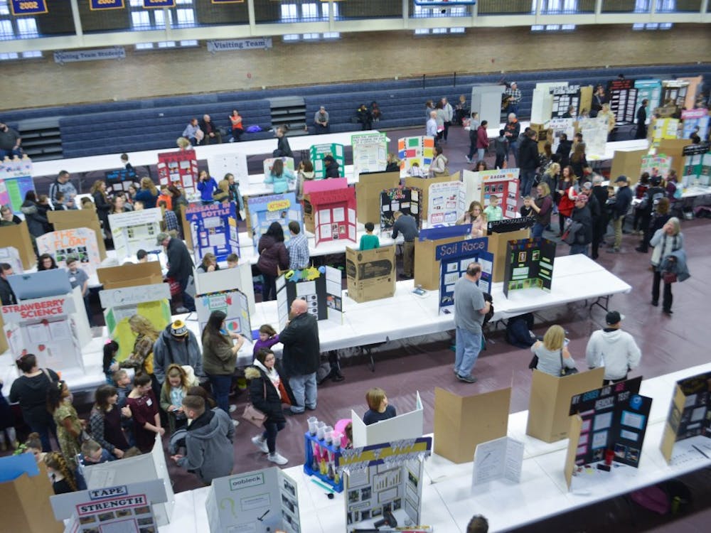 People look at several students' science fair projects at the East Central Indiana Science Fair Saturday, Feb. 16 in Ball Gym. &nbsp;Students who placed in each division will move on to the state science fair later this year. Jacob Musselman, DN