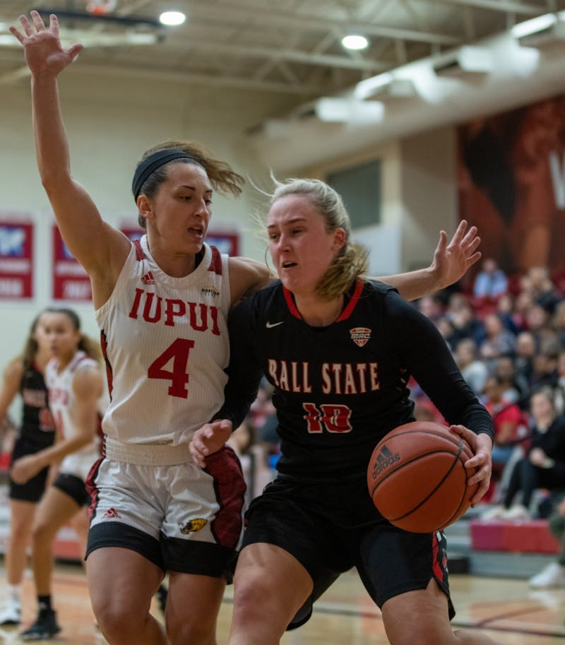 Sophomore forward Thelma Dis Agustdottir charges IUPUI Junior guard Holly Hoopingarner Nov. 5, 2019, in the IUPUI Gymnasium in Indianapolis, Ind. Hoopingarner had eight points against the Cardinals. Jacob Musselman, DN