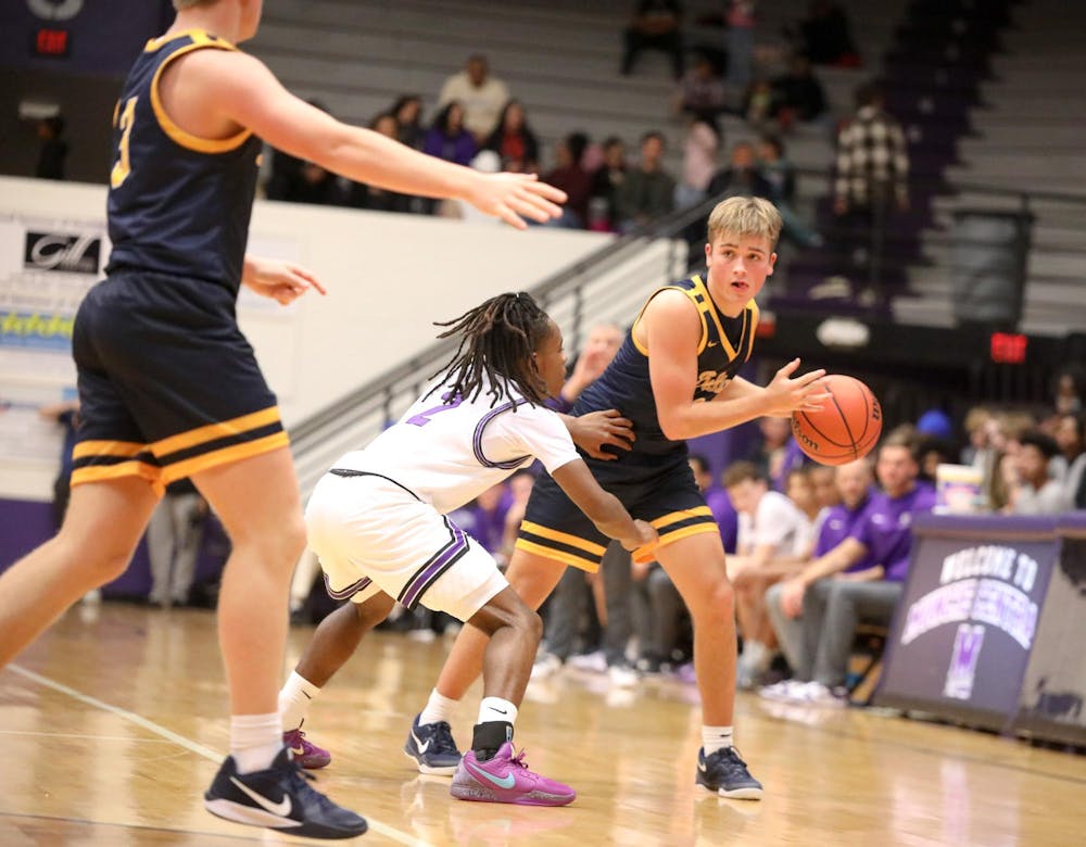 Delta senior Cooper Bratton looks to pass to a teammate Dec. 21 against Muncie Central at the Muncie Central Fieldhouse. The Eagles defeated the Bearcats 49-46. Zach Carter, DN.