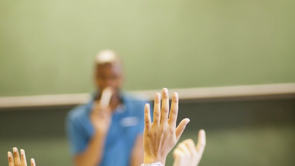students arms up in classroom