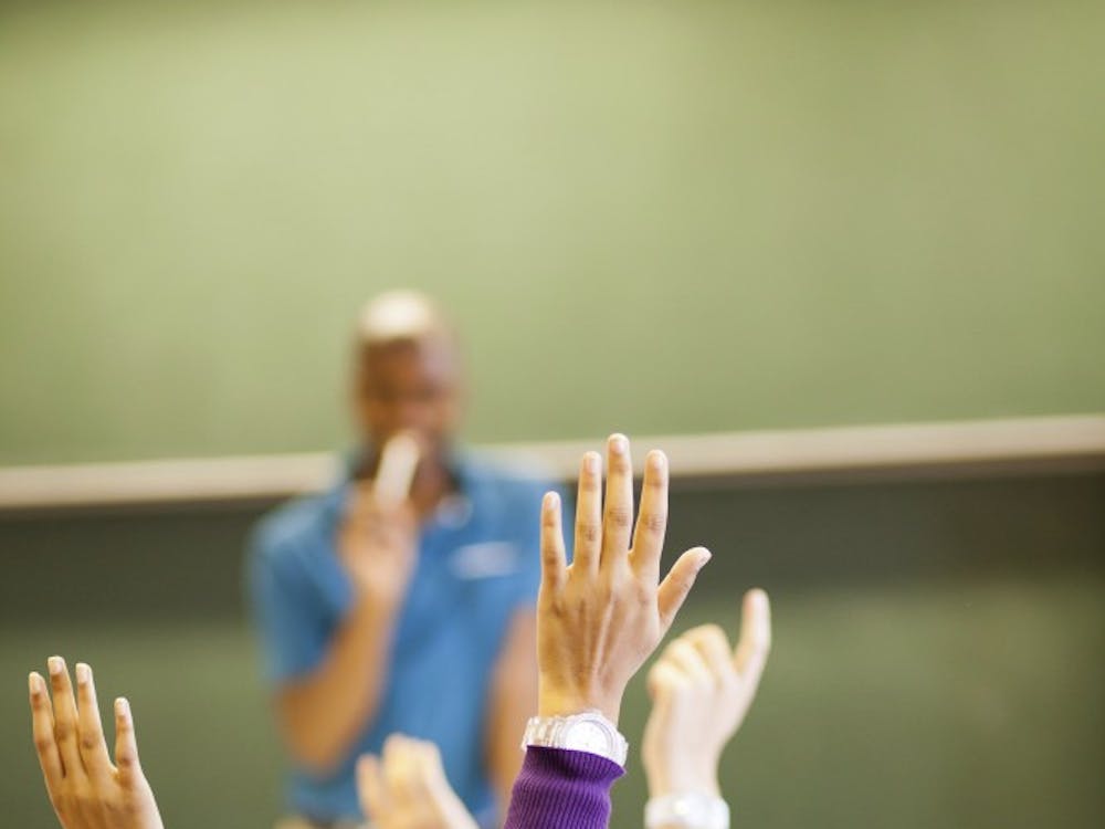 students arms up in classroom